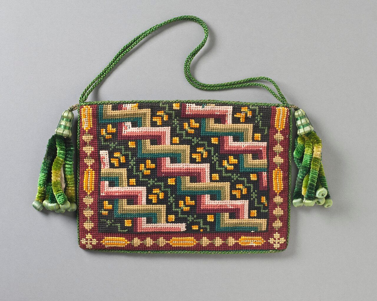 Woman's Purse c. 1840. Cotton canvas with wool needlepoint (Berlin work), silk-braided cord, and silk chenille tassels, Europe, 6 x 8 in. (15.24 x 20.32 cm), Costume and Textiles collection, M.2007.211.280.