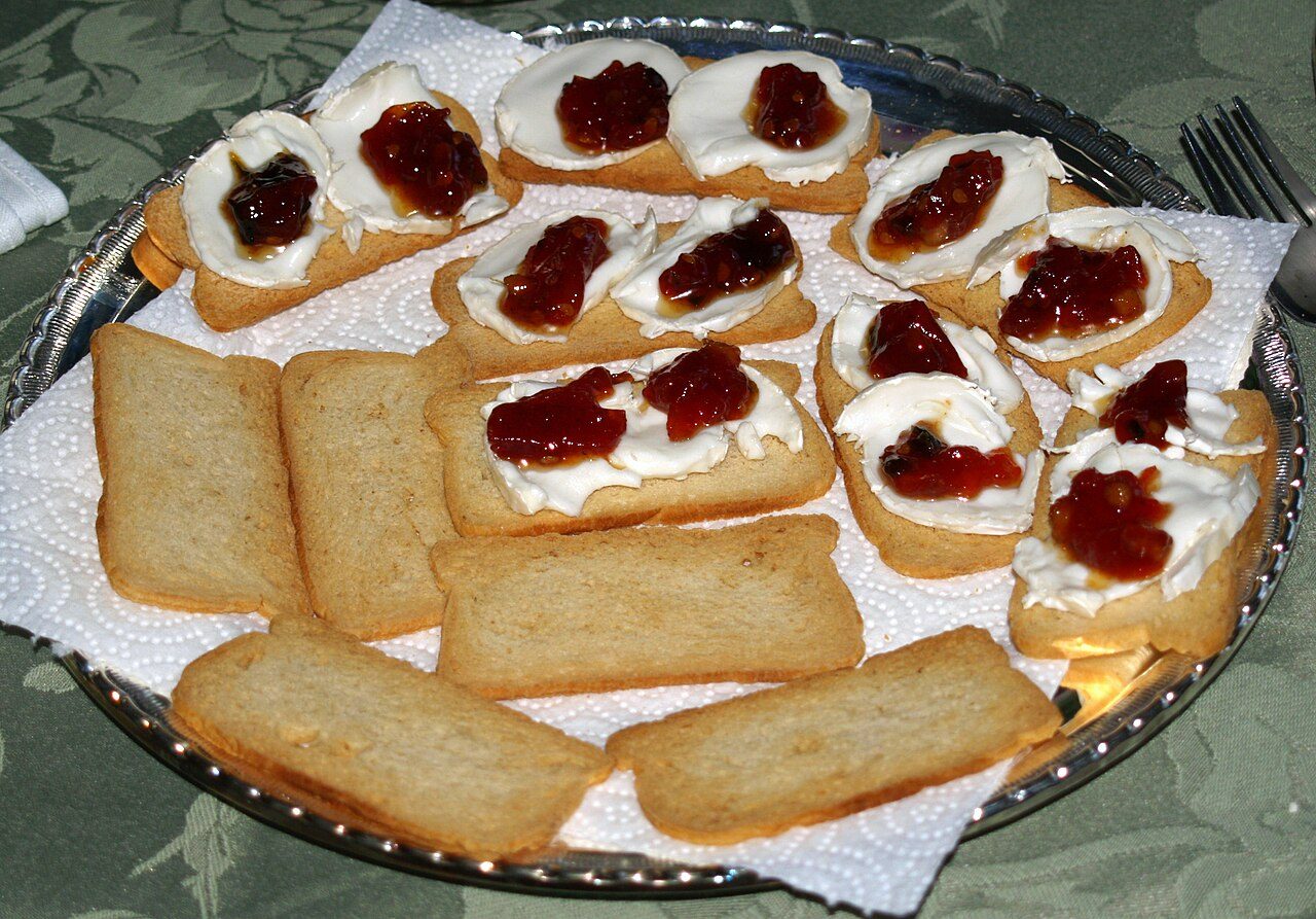 Melba toast topped with goat cheese and tomato jam