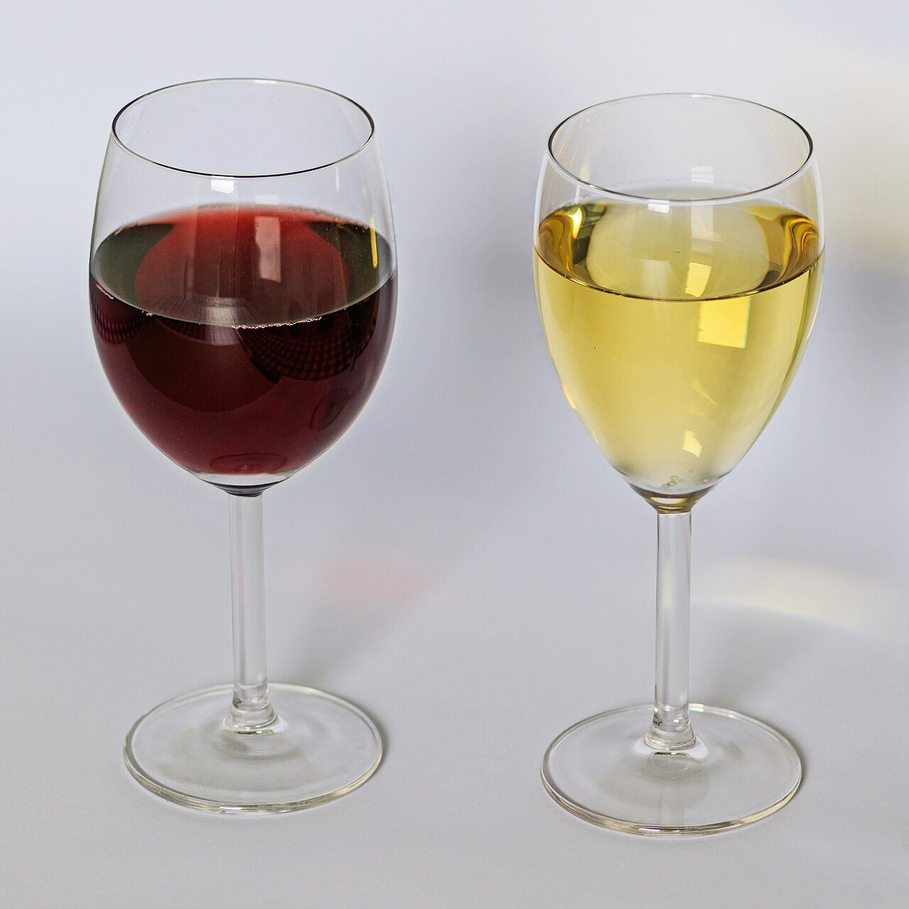 A glass of red wine (left) and a glass of white wine