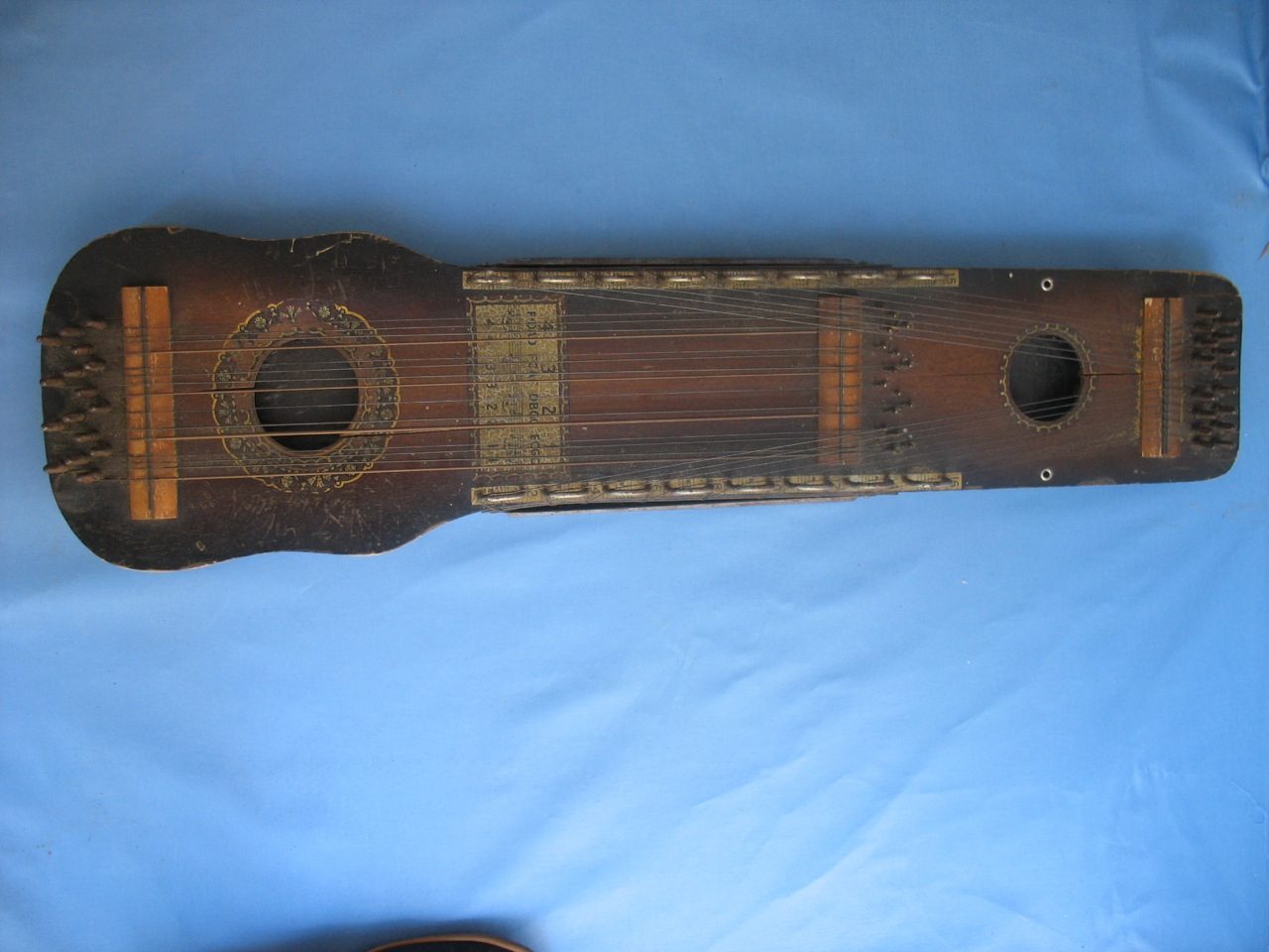 Ukelin Wooden, stringed instrument 32 strings - 16 strings for bowing, another 16 strings for chord strumming (missing one) vintage Piece on side loose Cracks to several areas Most likely un-playable Price $39.00 UKELIN Distributed Exclusively by the Manufacturers' Advertising…