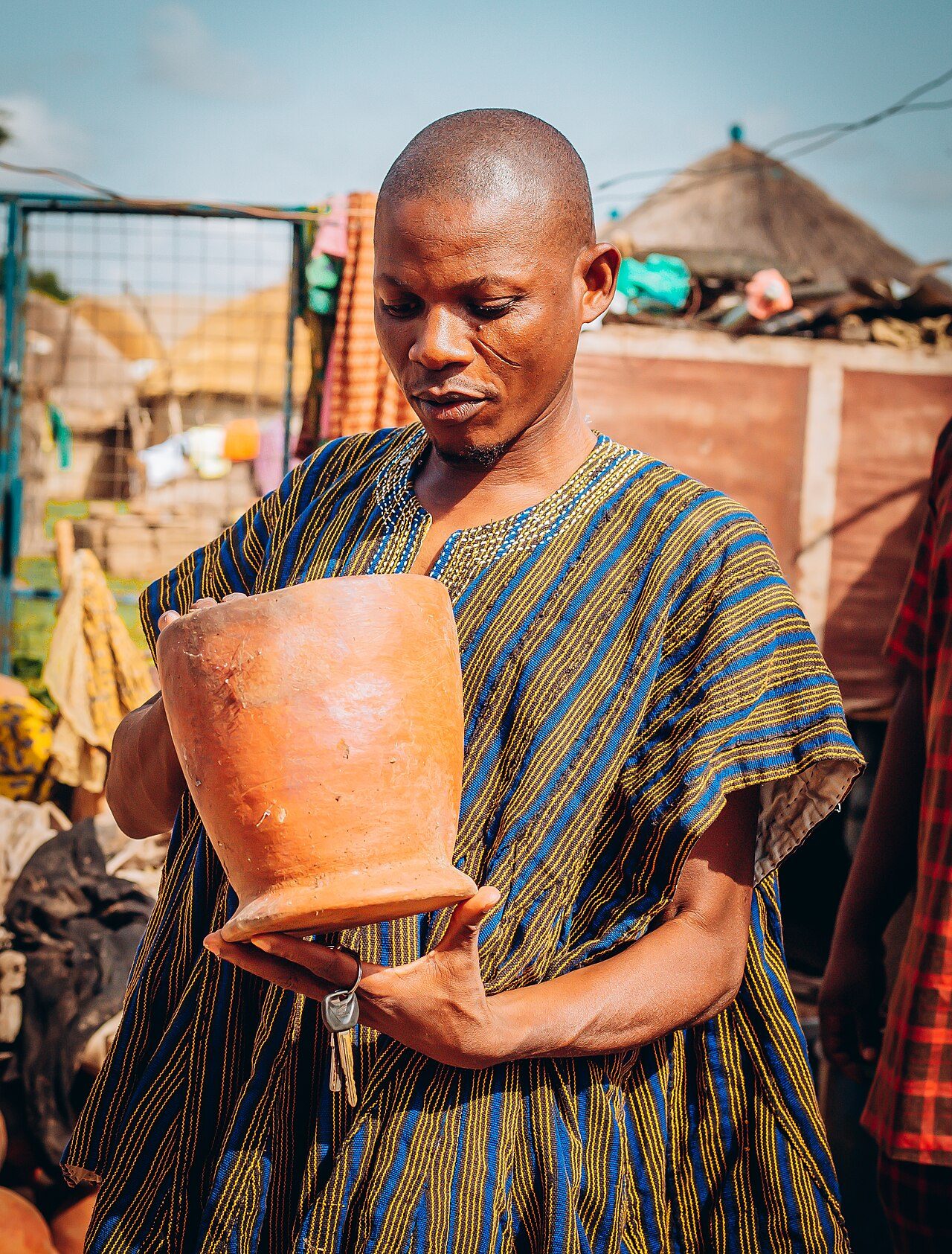 A dagomba man holding a bowl made of clay in northern Ghana