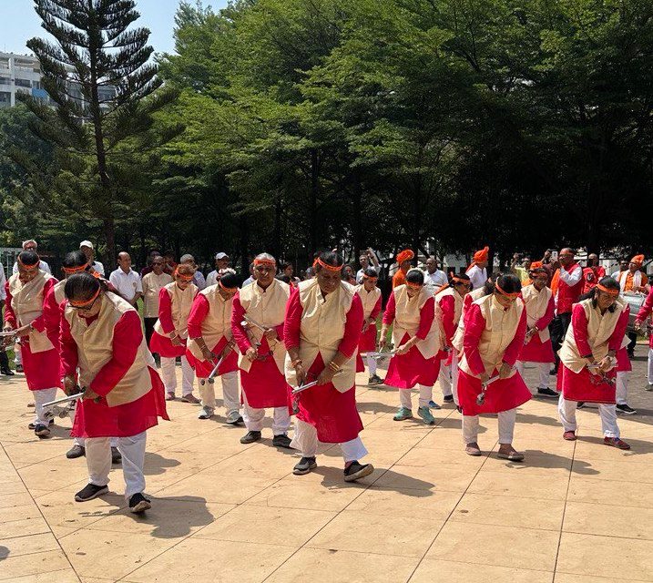 Group of dancers from Maharashtra, India in a formation performing a local folk dance with Lezim (cymbal like musical instruments).