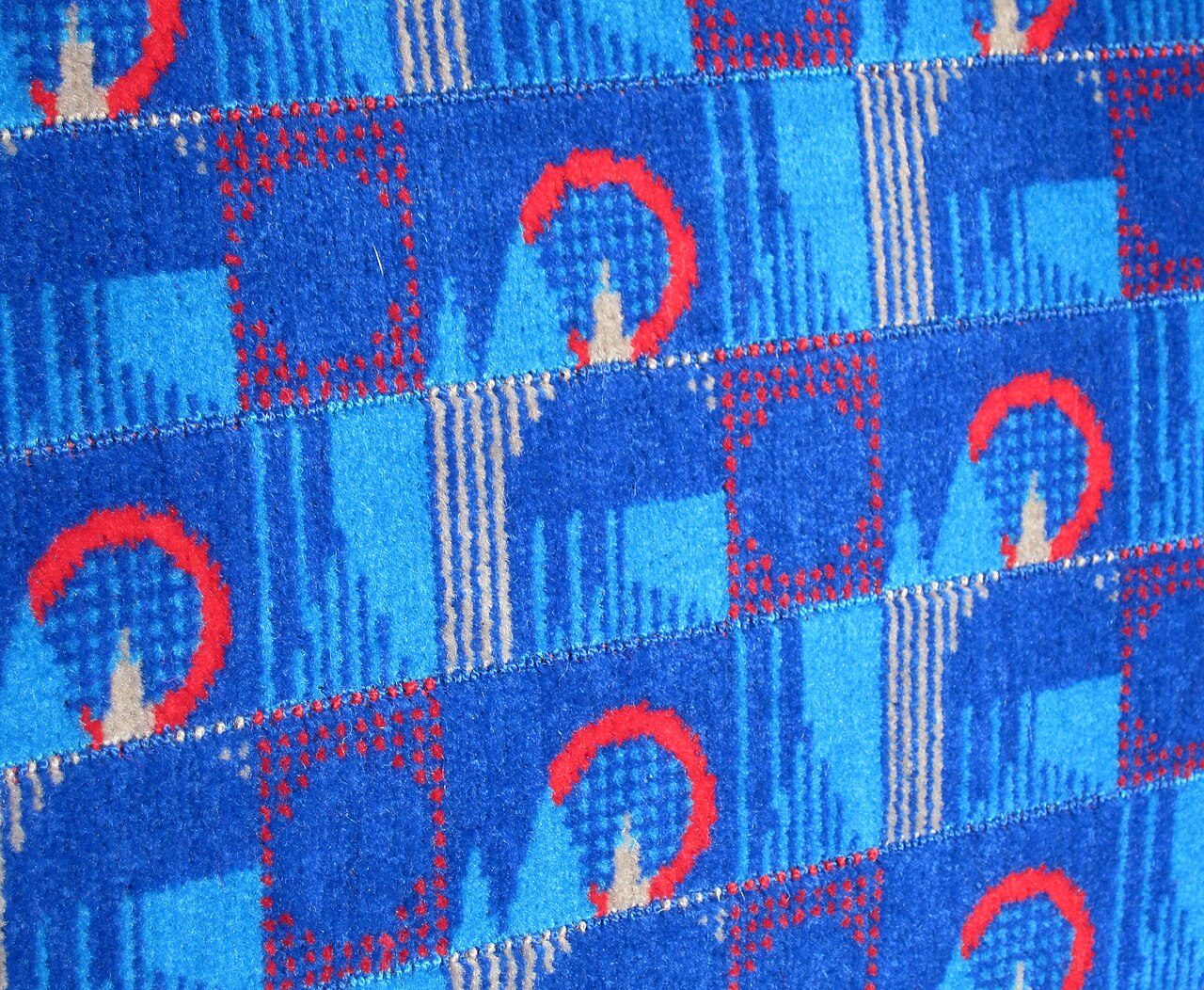The "Barman" design of Transport for London seat covering fabric ( moquette ). Designed by WallaceSewell, according to TfL, "WallaceSewell's starting point was London landmarks which were turned into abstract primary shapes like circles, triangles and squares allowing customers…