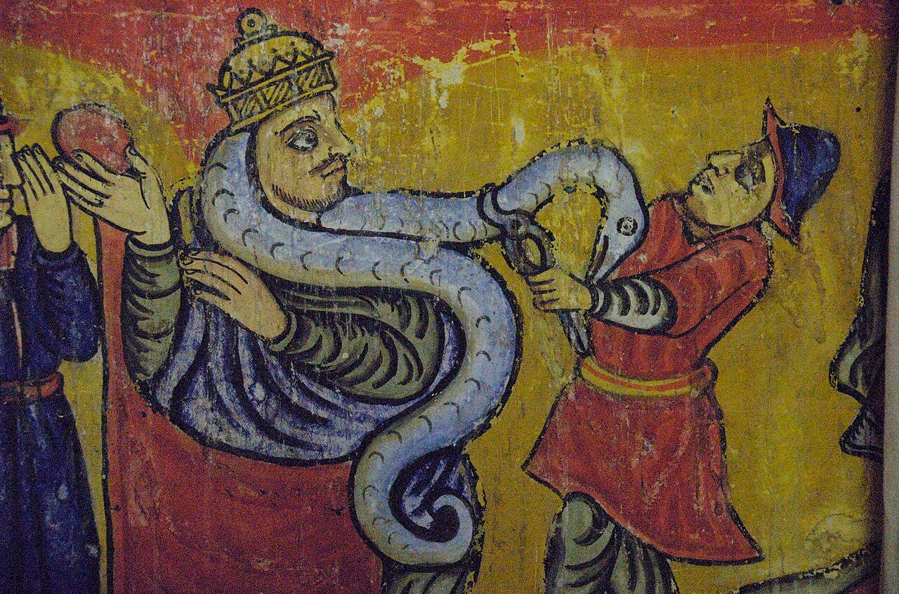 This is one of several scenes in the Church of Ura Kidane Mihret depicting snake-like creatures. In this panel, the snake appears to have gotten out of hand, and the man on the right is in the process of lopping off the snake's head with what look like metal shears. One must…