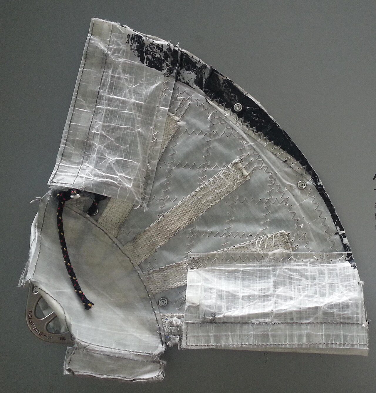 The Clew (lower rear corner) of the gennaker sail of an AC45 class racing catamaran, made of Cuben fiber with Nylon strips. An exhibit in the California Academy of Sciences.
