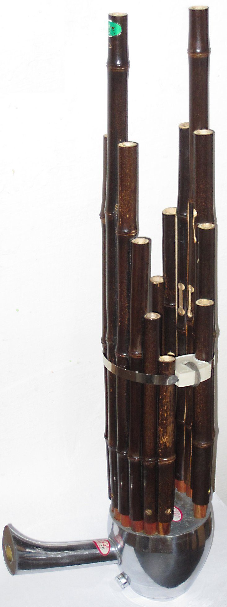 The sheng (Chinese mouth organ) is a free reed wind musical instrument. Height is 55cm (22 inches). It has 17 pipes, each pipe has one reed.