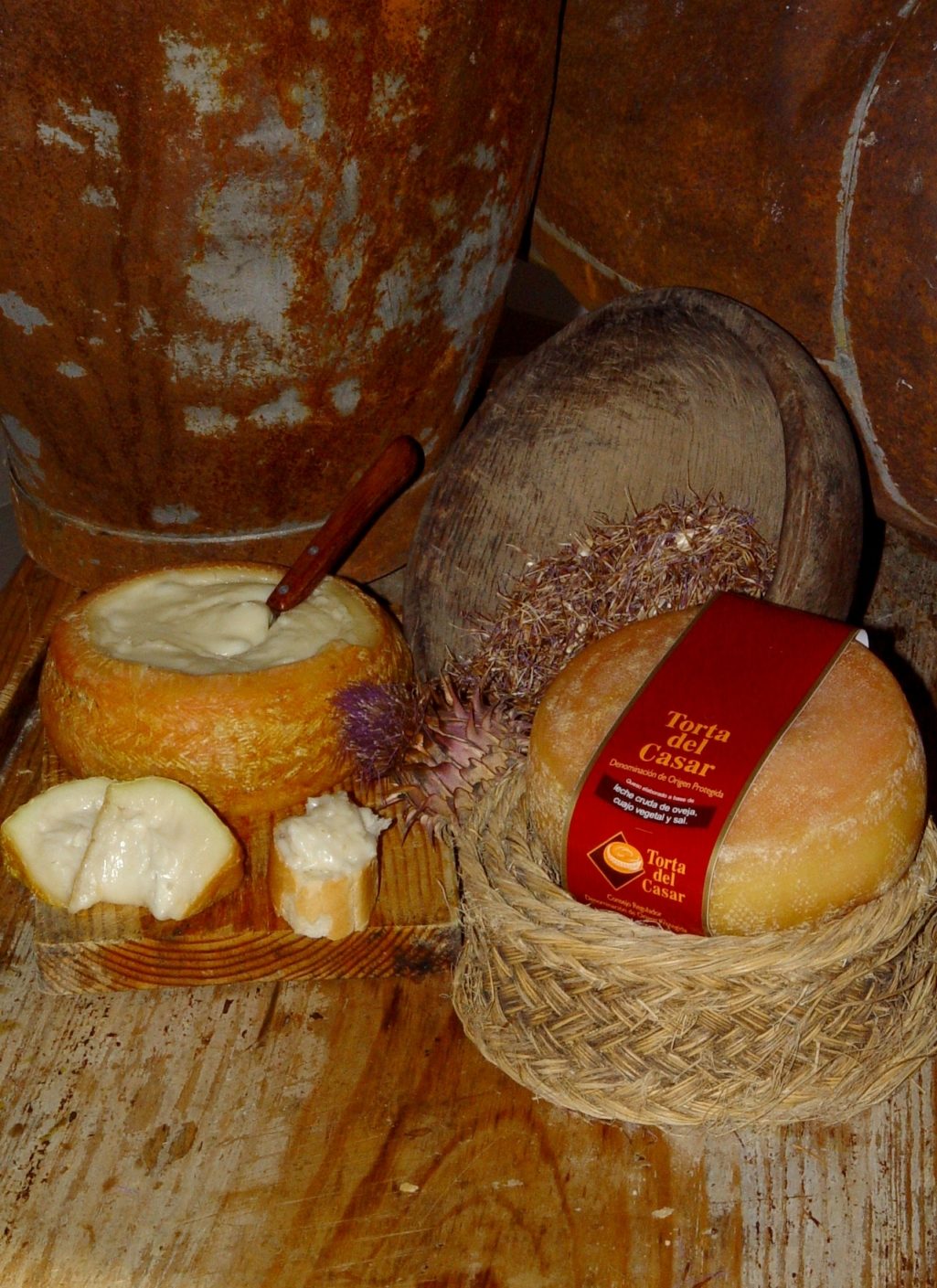 Photograph of PDO cheese Torta del Casar (Spain) with its certification label, opened in its two forms, top to spread, and traditional cut