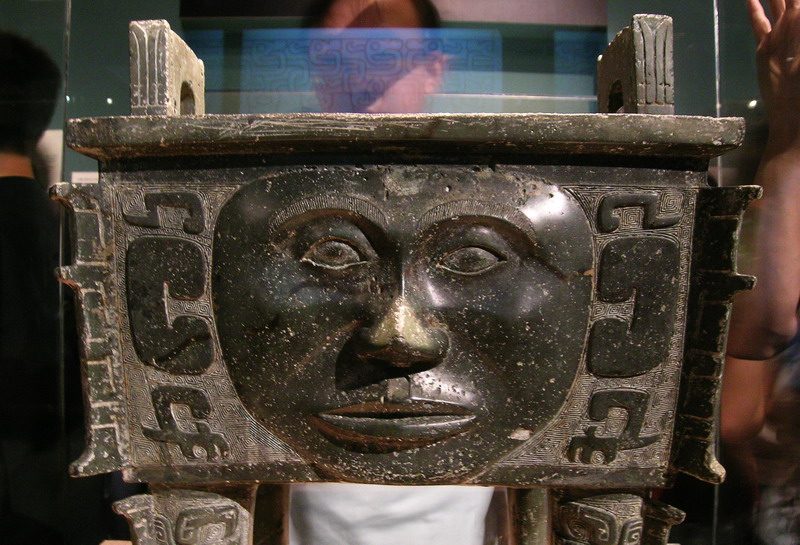 Bronze square fangding (cauldron) with human faces, unearthed in Zhaizishan or Zhaizi Mountain, in the town of Huangcai, Ningxiang, Hunan, in 1959, collection of Hunan Provincial Museum. Take photo in The Chinese Memory , Capital Museum in Beijing on 2008. Photo Permited.