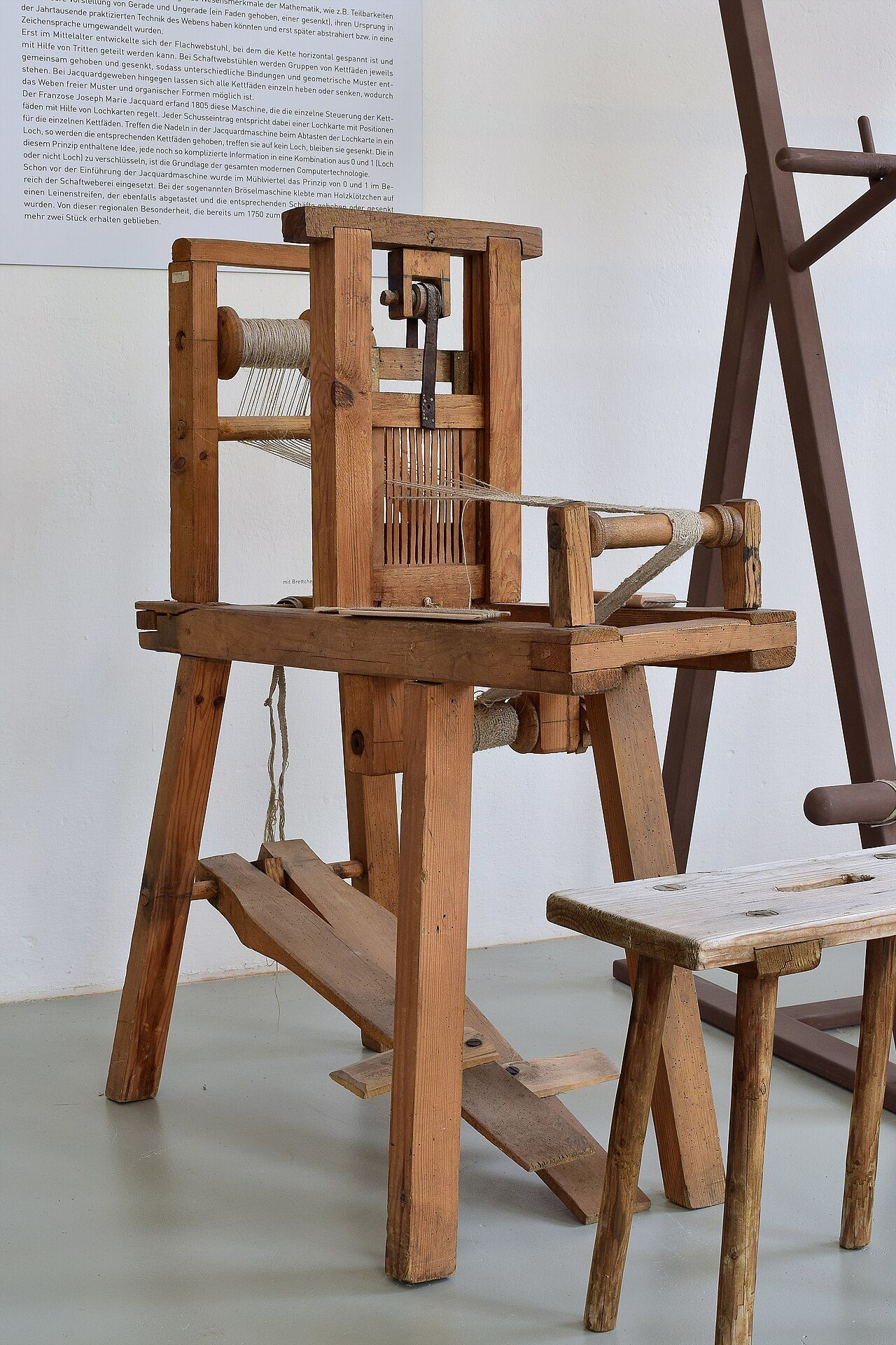 An inkle loom with a rigid heddle. A rigid heddle has half the warp threads threaded through vertical slits, and the other half threaded through round holes. As the heddle is raised and lowered, the threads in the slits stay put, and the threads in the holes are raised and…