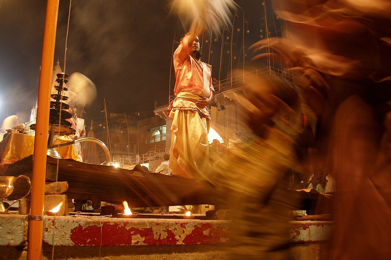 Evening aarti ritual at Dasaswamedh Ghat ('Main Ghat'). People gather to launch floating oil lamps onto the Ganges, a major part of the city's devotional activity. Varanasi, India.