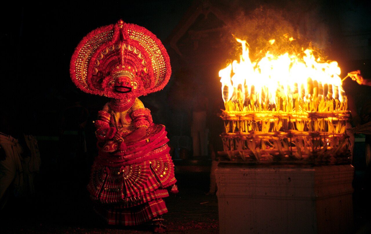 Kathivanoor Veeran theyyam performing . A bunch of torches seen enlighten on a stone block which is known as Chemmarathi Thara which depicts Chemmarathi , the widow of the protagonist.