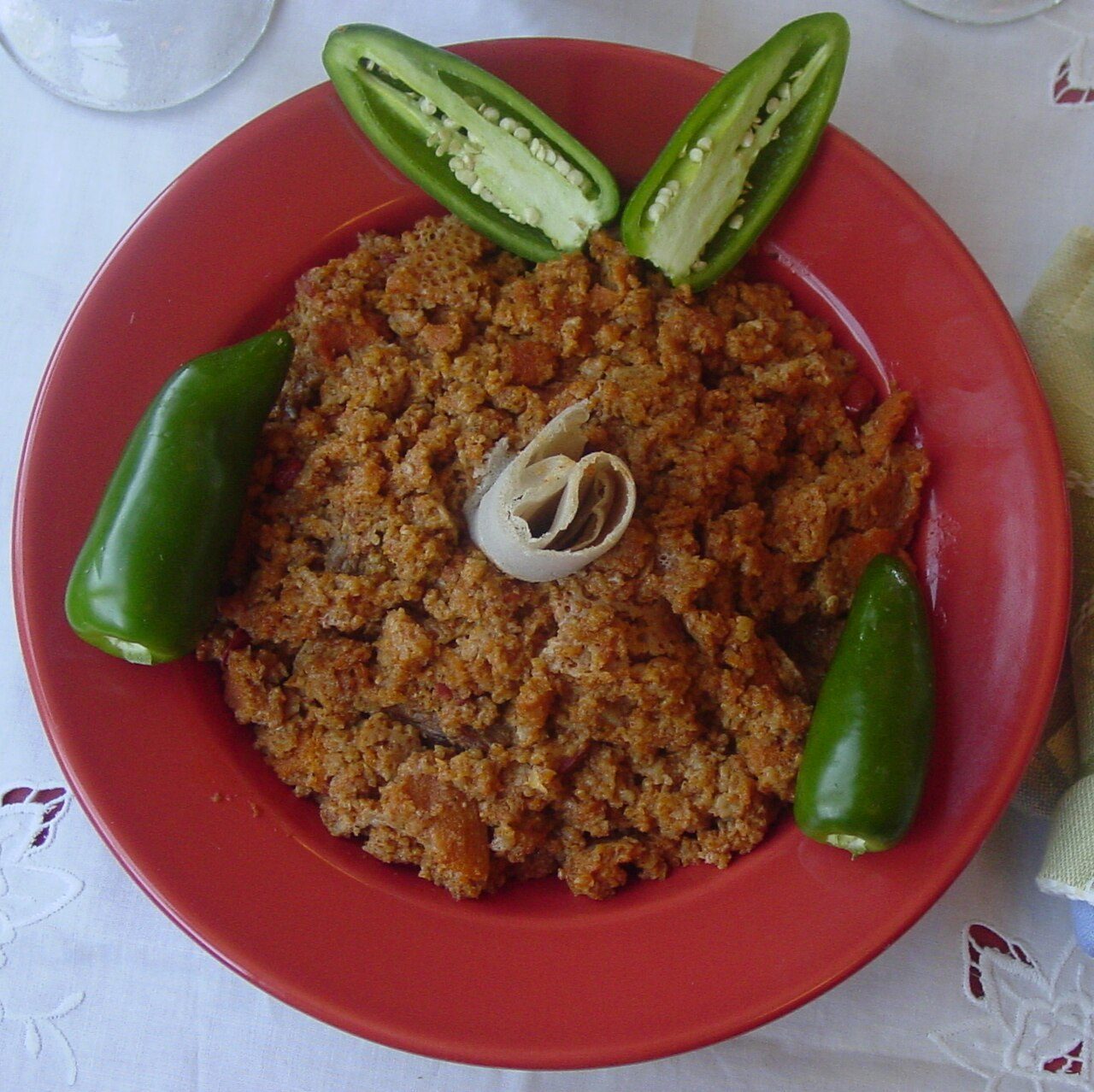 Taita fit-fit is a traditional Eritrean food, here served with jalapeño peppers.