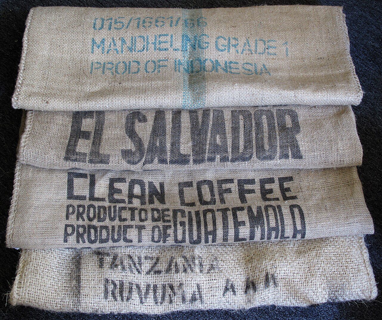 Three empty coffee sacks made of jute (burlap). The sack from Tanzania appears to be made of sisal.