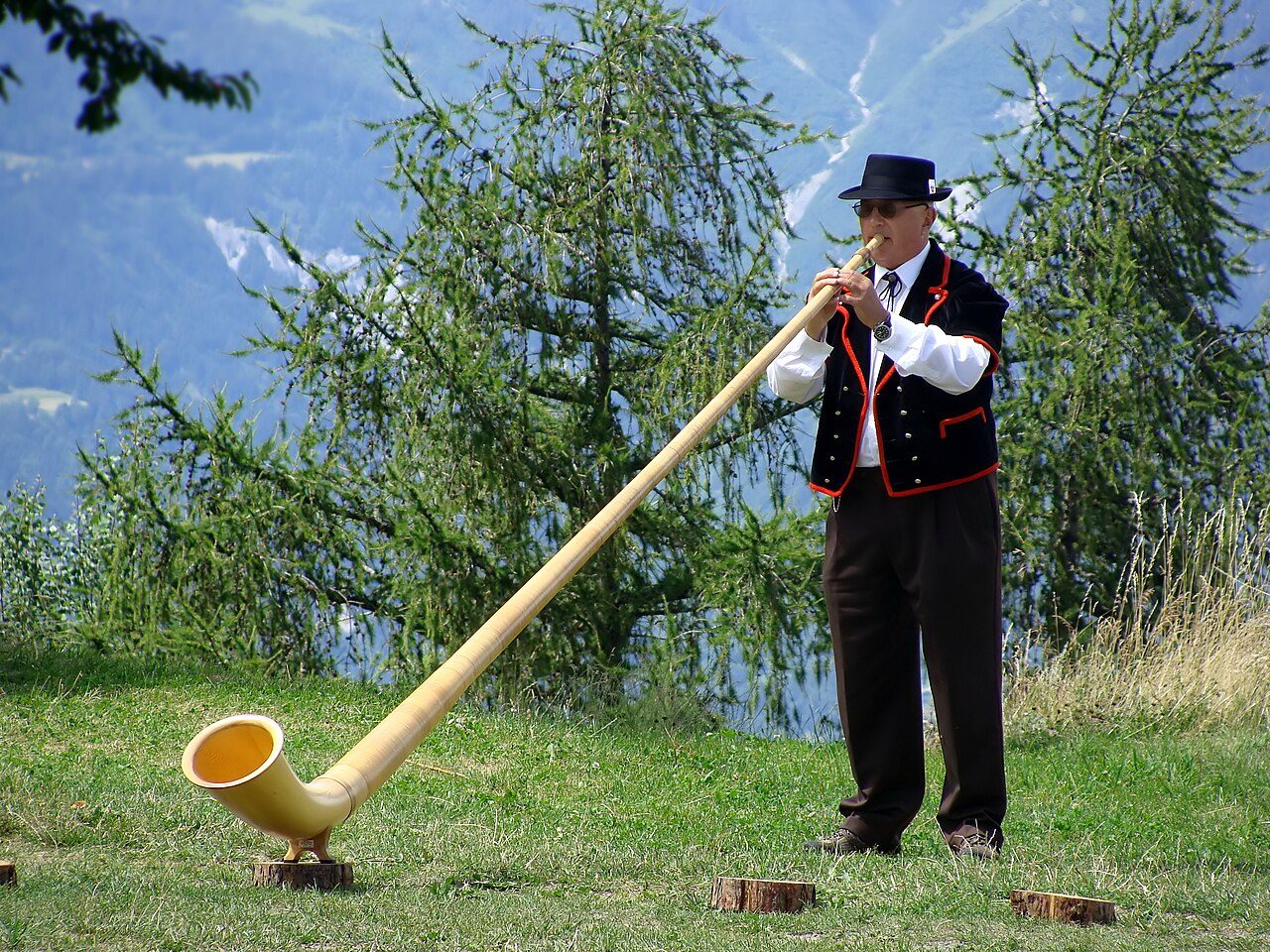 Alphorn player in Nendaz, Wallis, Switzerland.