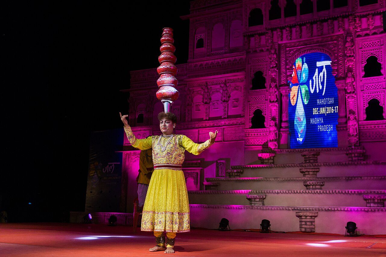 Dancer performing traditional dance of Malwa by balancing earthen pots during the cultural program at Jal Mahotsav 2016-17, Hanuwantiya, Madhya Pradesh.