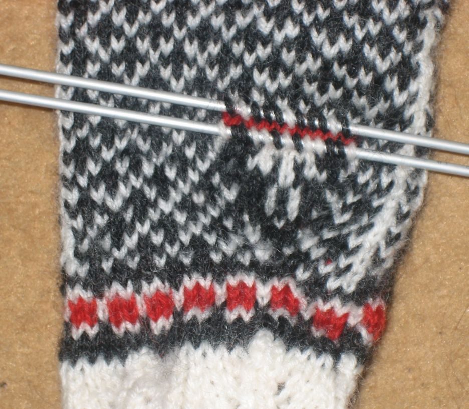 Picking up stitches to make a thumb for a mitten.