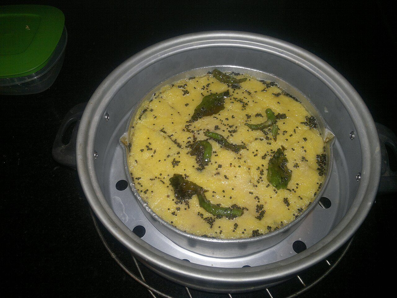 this is what 'nylon khaman dhokla' looks like before it is cut up into convenient,bite-sized pieces. I must say this variety of Dhokla is really soft and spongy.