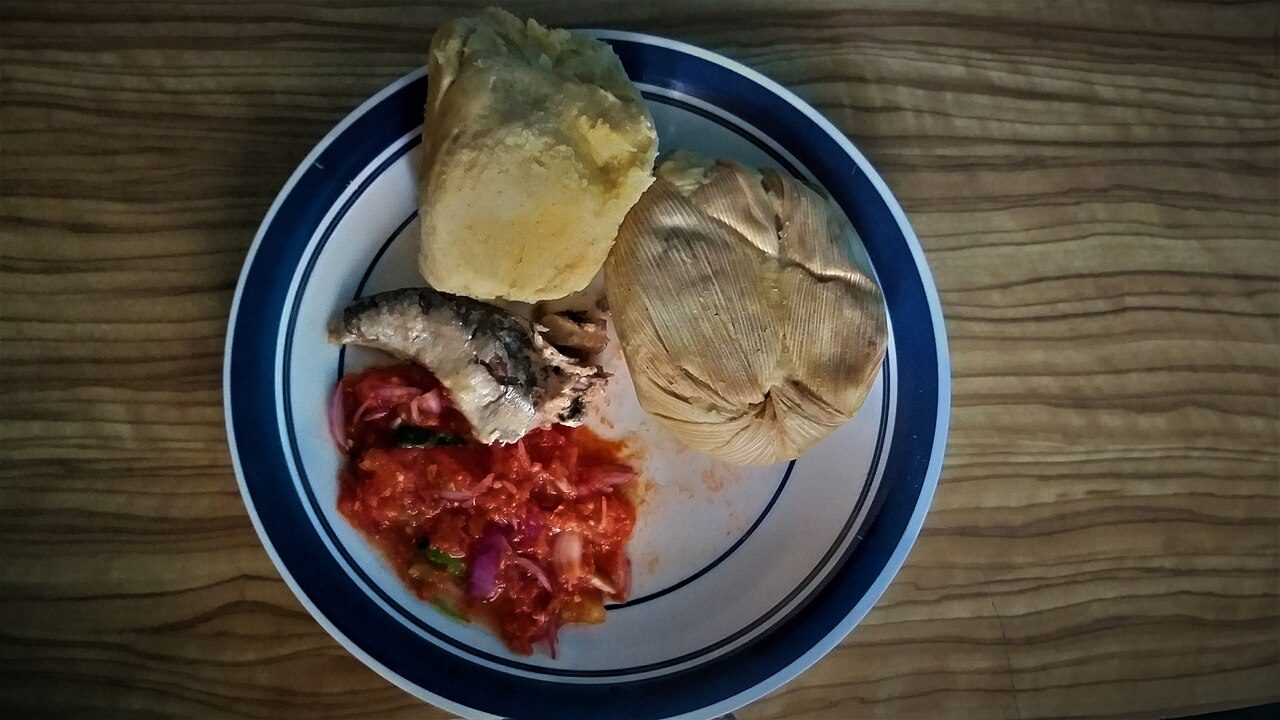 Kenkey or kormi or kokoe or dorkunu is a staple dish similar to sourdough dumpling from the Ga and Fante-inhabited regions of West Africa, usually served with pepper sauce and fried fish or soup, stew.