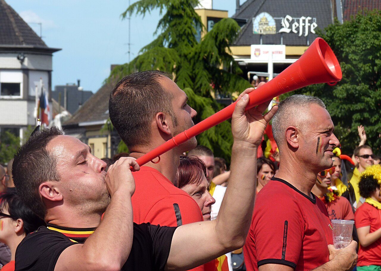 Supporter of the Belgian national football team with vuvuzela, photo taken on the town square of Mouscron, Belgium before the match Belgium - Russia of the world cup 2014 broadcast on large screen.