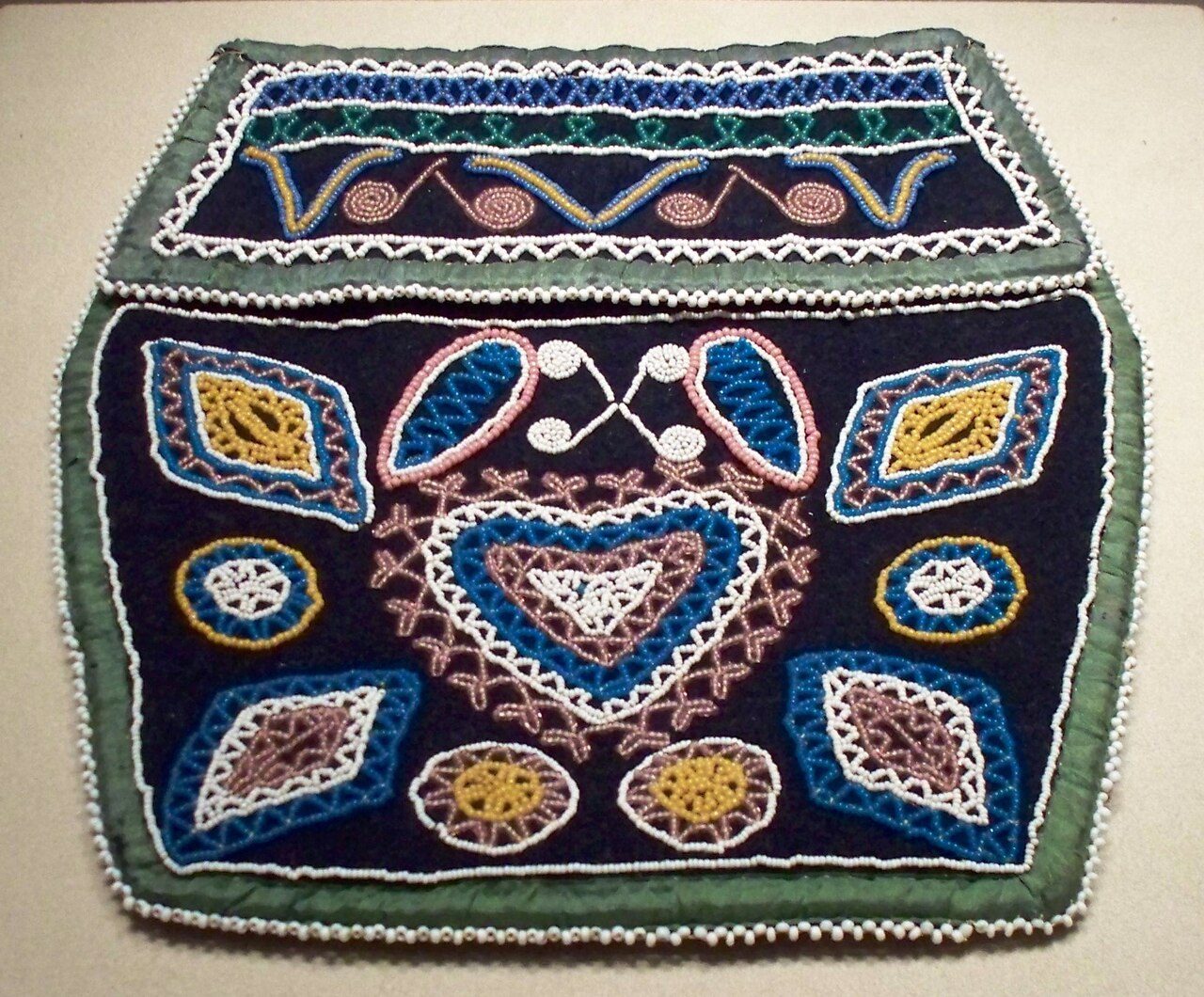 woman's bag with heart design Culture or people Micmac people Creation date 1870-1910 Materials cloth, glass beads, cotton thread Dimensions L: 7 in. Location Native Art of the Americas Gallery Credit line Emma Harter Sweetser Fund Accession number 76.231 Gallery Label The form…