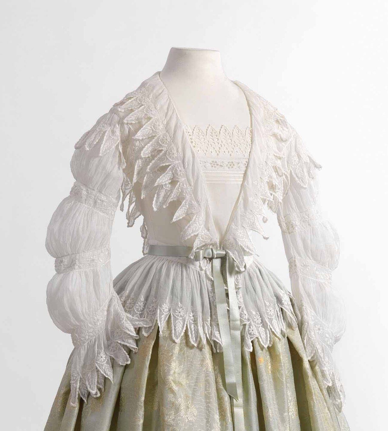 Anonymous, Morning blouse (matinee) in white cambric, decorated with embroidery, 1850-1855, and silk skirt with woven stripe motif, ca. 1850. Jacoba de Jonge Collection in MoMu - Fashion Museum Province of Antwerp, www.momu.be Photo by Hugo Maertens, Bruges. MoMu Collection…