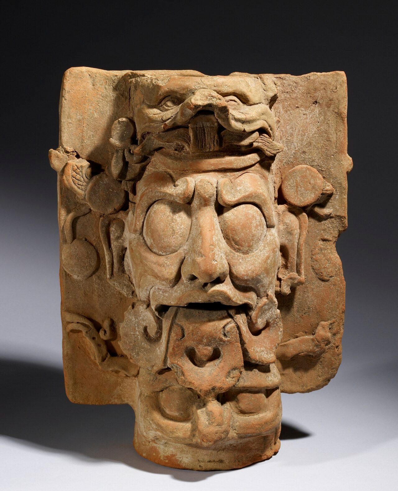 Made up of smoothed sheets and coils of coarse orange clay, this "incensario," or incense burner, depicts one of the Palenque Triad of deities that art historians call "GIII." The Maya called him Kinich Ajaw, or "Sun Lord." He is shown here with his trademark nose, and shell and…