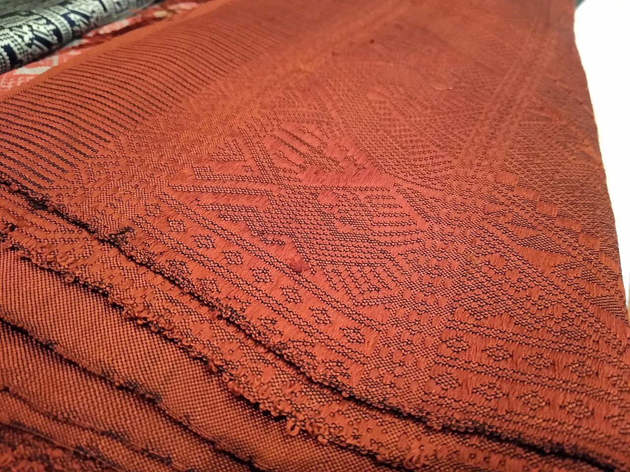 A silk pha biang for sale at the Lao Textile Museum in Vientiane. Label: Pha Biang Kit Lai Nark Tai Kuea Silk/Hand Woven Made in Laos US$500