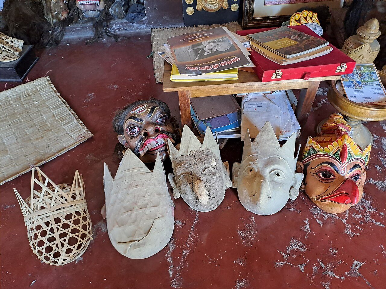 It is shown here the stages of making a mask for Bhavna. The first stage is to make a frame of bamboo extracts and then and give it the basic shape. Then with paper and clay the shape is made more prominent. Then a a layer of clay and cow dung is layared. After that again the…
