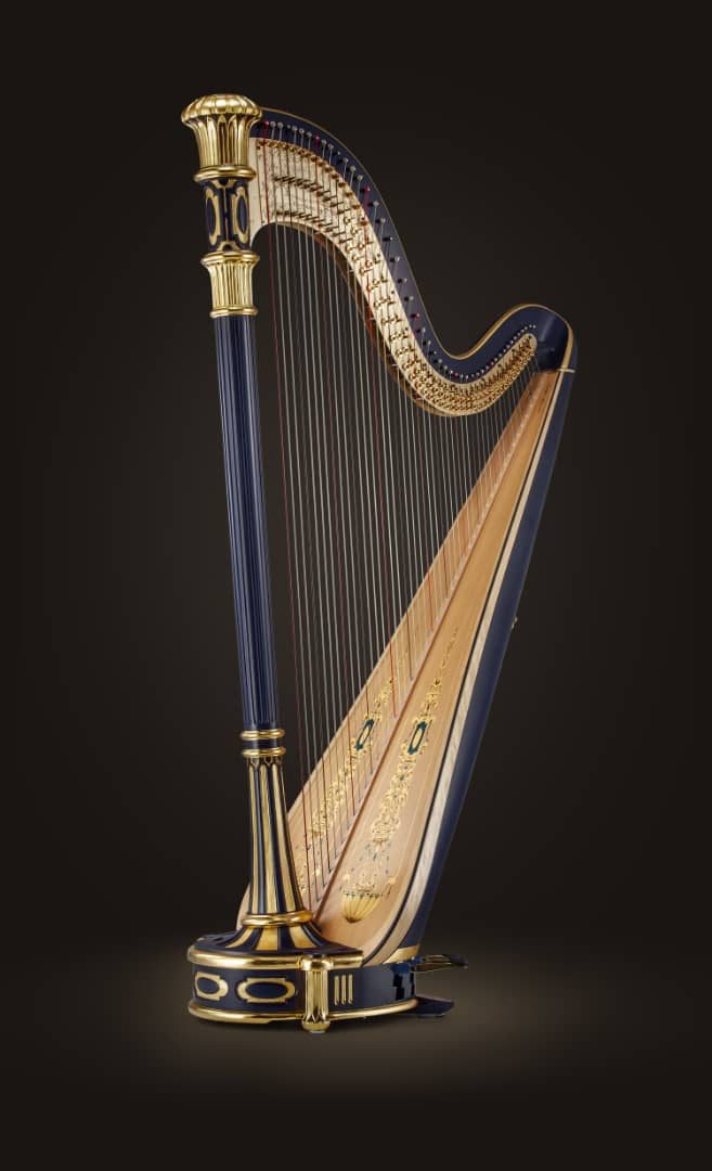 A picture of a musical instrument called a harp against a black background