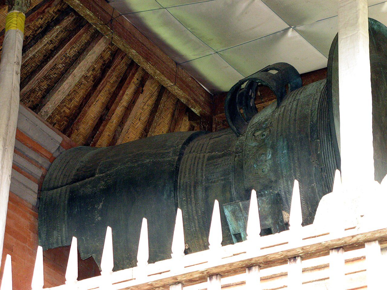 The drum is as tall as a person, measuring 186.5 cm (6.12 ft) high. It was cast from bronze by the lost-wax method in two sections, the body and the tympanum, which were then joined together. It is hard to estimate its age, but many writers consider it to be pre-Hindu, from the…