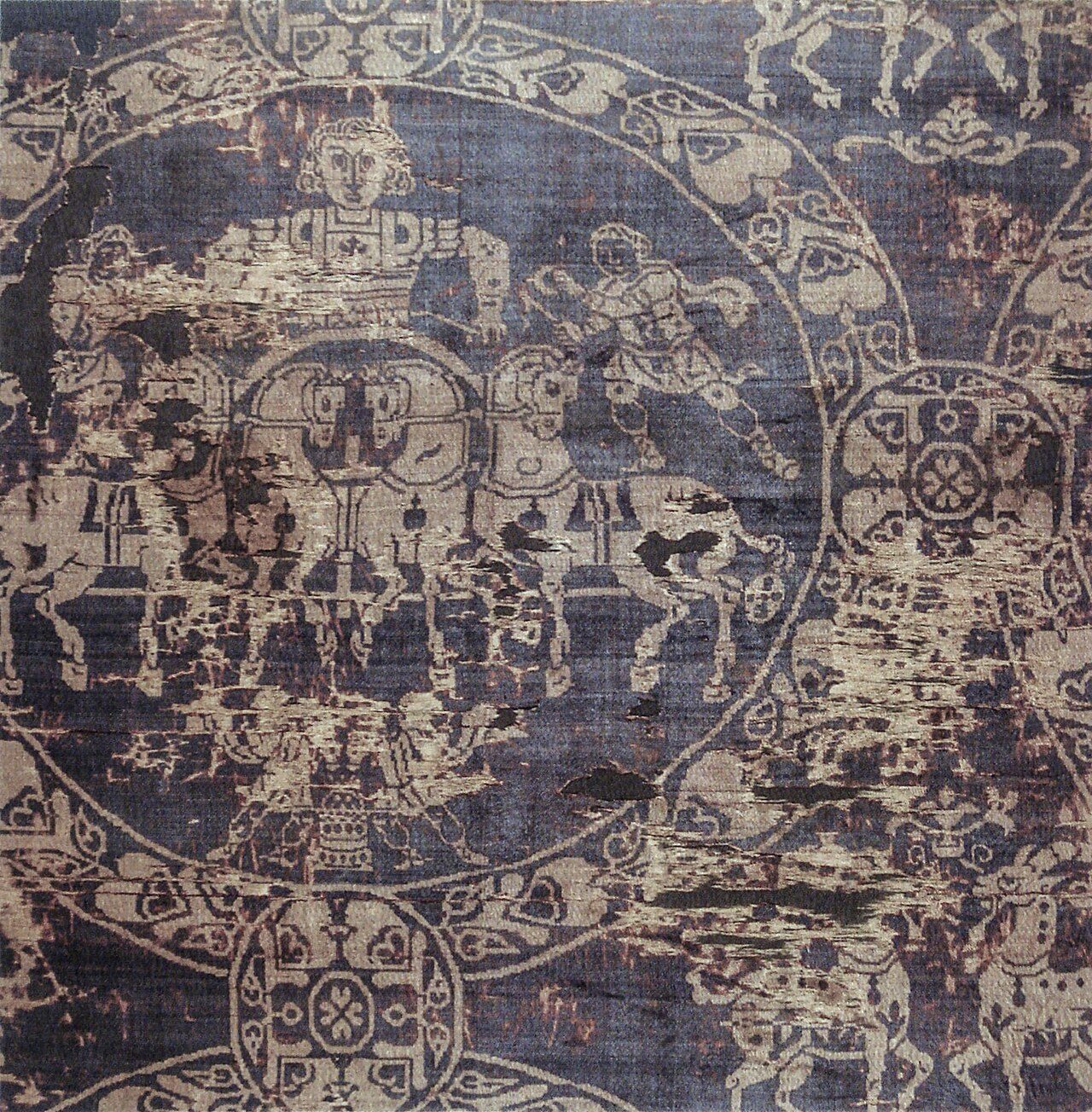 The Shroud of Charlemagne, a polychrome crimson-hued silk with a pattern showing a quadriga , Byzantine, 8th or 9th century. Paris, musée national du Moyen Âge. This section was cut in 1850 from the shroud in the Aachen Cathedral Treasury, where a section of about the same…
