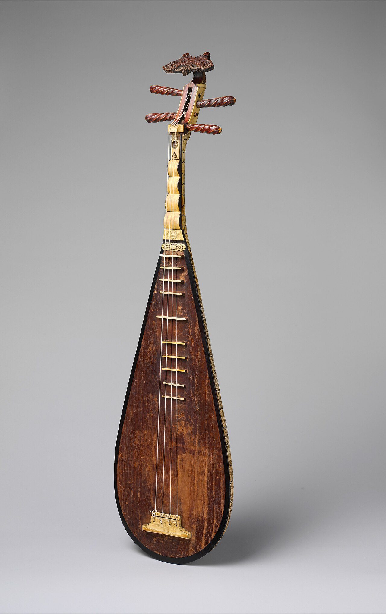 Pipa (琵琶) Chordophone-lute-plucked-fretted The spectacular back and sides of this unique Ming-dynasty instrument feature more than 110 hexagonal ivory plaques, with thinner bone plaques on the neck. Each plaque is carved with Taoist, Confucian, or Buddhist figures and symbols…