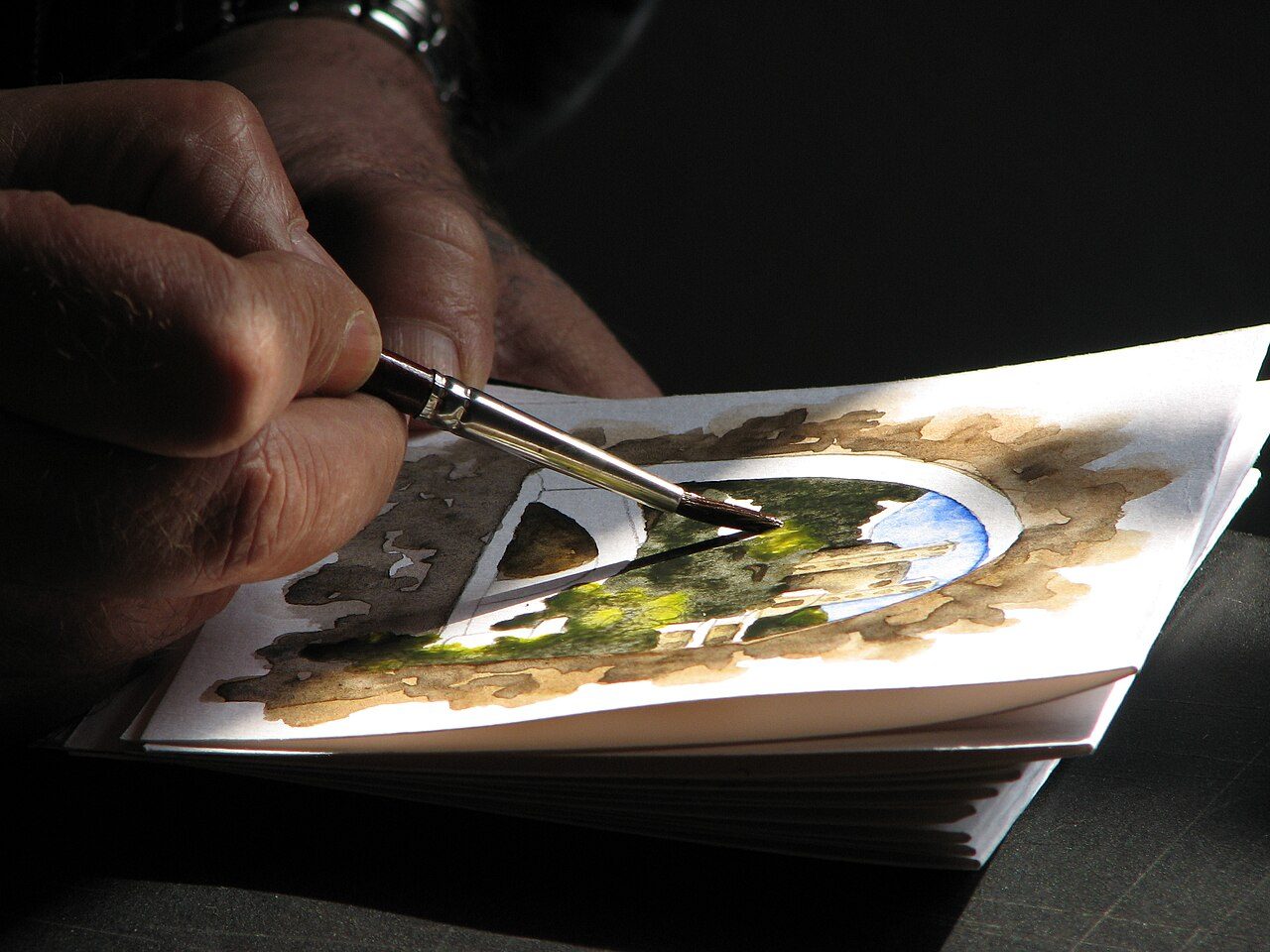 A watercolor painter working in Dolceacqua (Liguria, Italy).