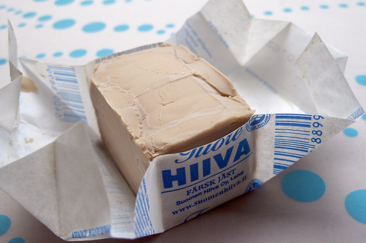 An opened 50 g package of compressed yeast, produced and bought in Finland.