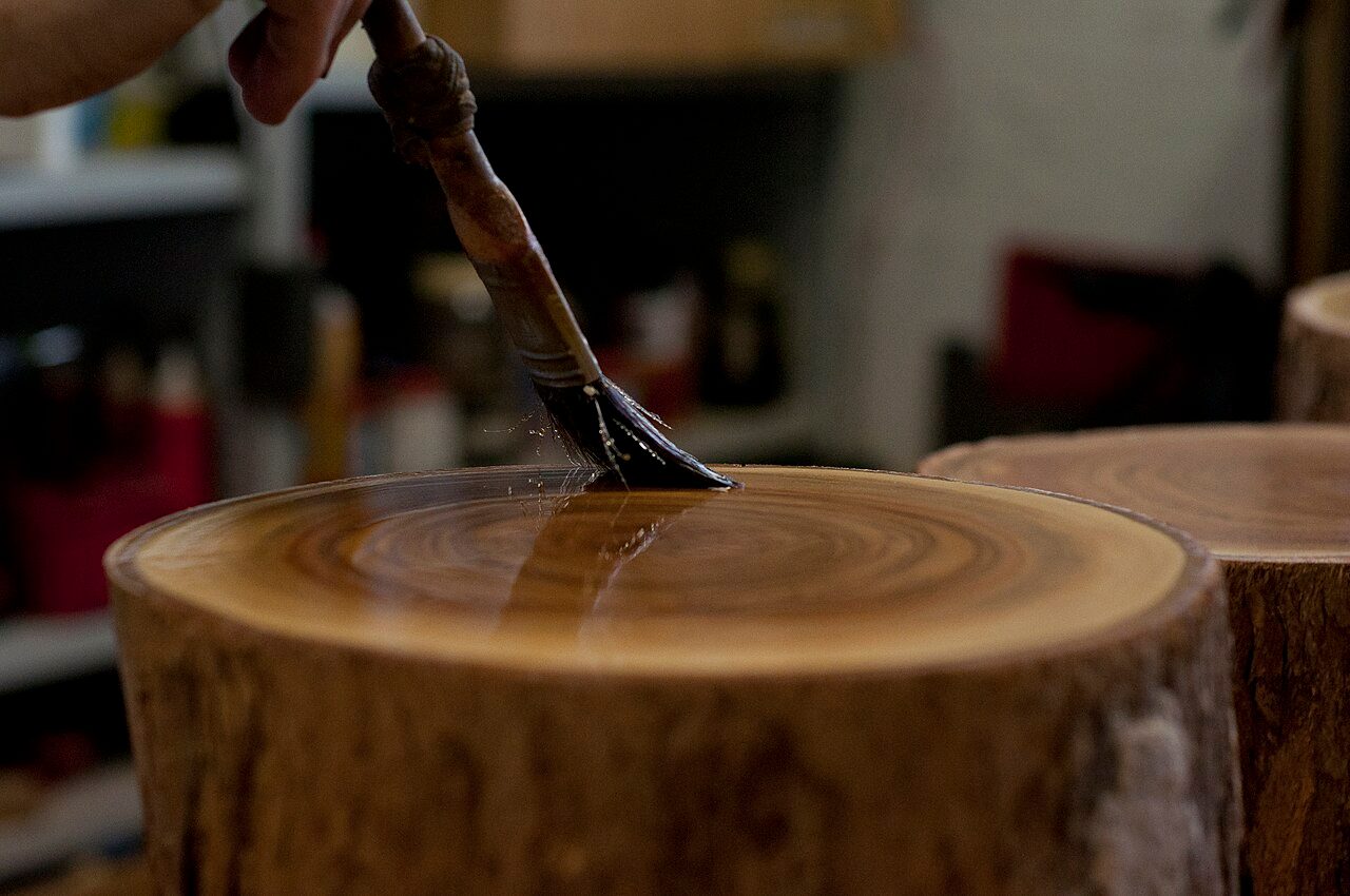 Lacquering the tops of the tree stumps.