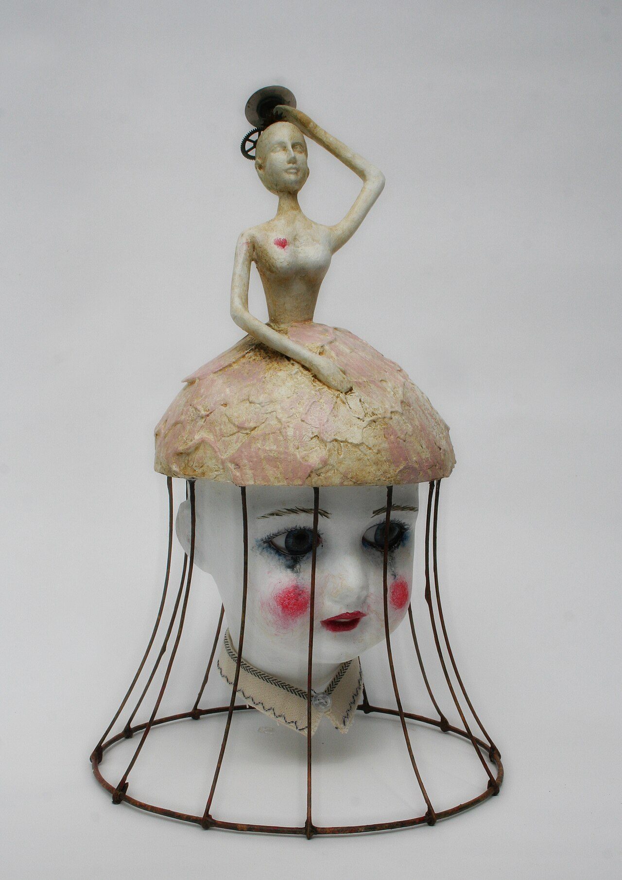 Sculpture, in mixed media: Head of Pre-1930 doll, resin doll, old clock parts from old clocks and gears, polyester resin, wire, acrylic patina.