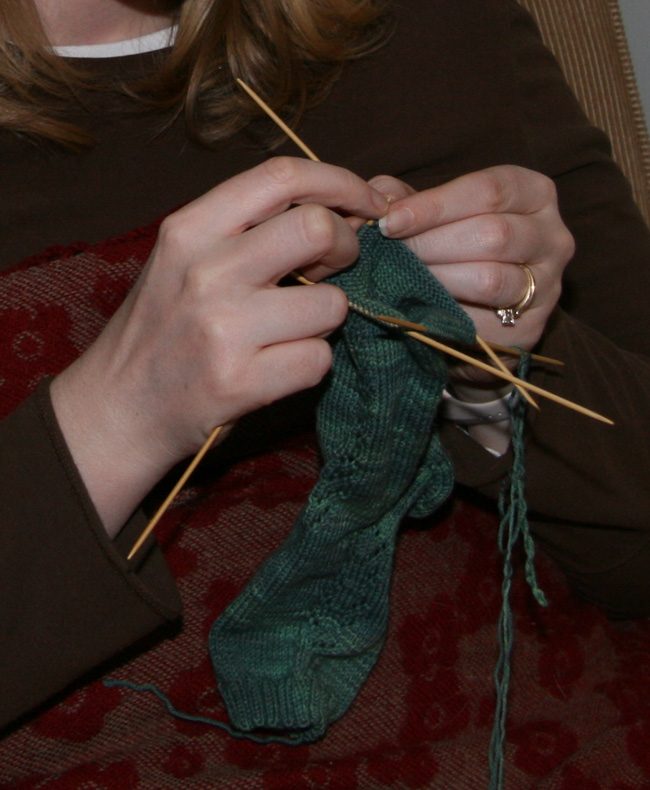 Knitting stockings on double-pointed needles. From original caption: Pattern from "Folk Knitting in Estonia" by Nancy Bush Knit in Tess Designer Yarns, bought at Stitches 2006