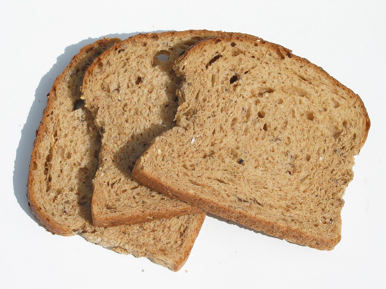 Three slices of stale brown, multigrain bread.