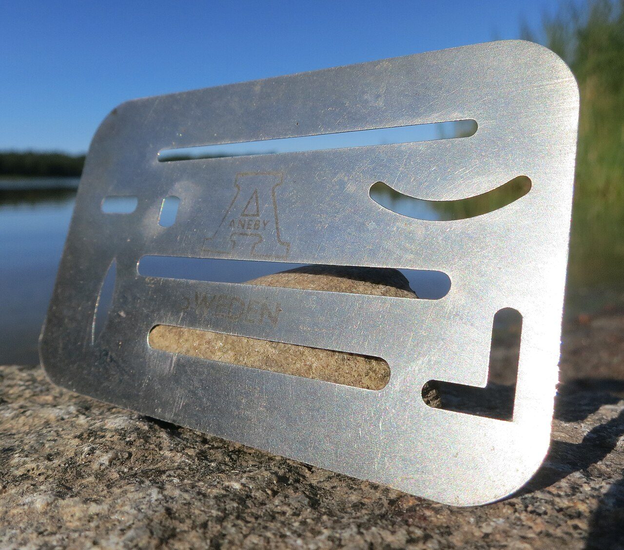 20th-century stainless steel erasing shield, marked Aneby, Sweden. Approx. 8 x 5 cm, 2 g.