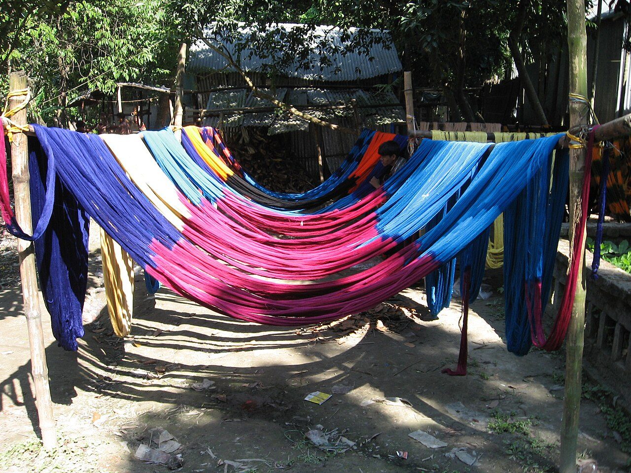 Coloured coton thread left to dry in Aloa village in Tangail