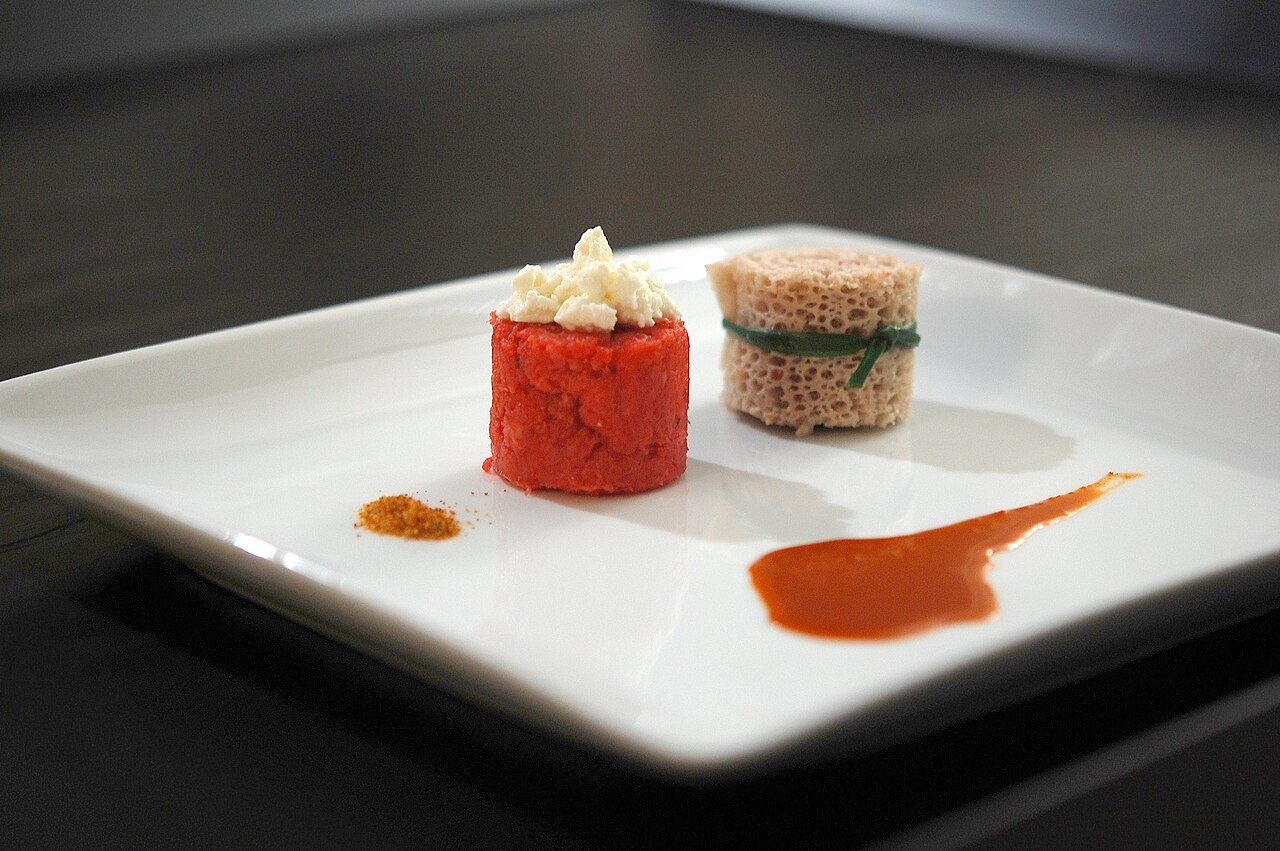 Beef Tartare ( Kitfo ) with Spiced Clarified Butter ( Niter Kebe ), Feta Cheese ( Ayib ), Teff Flatbread ( Injera ), Spicy Sauce ( Awaze ) and Bird Eye Chili Spice ( Mitmita )