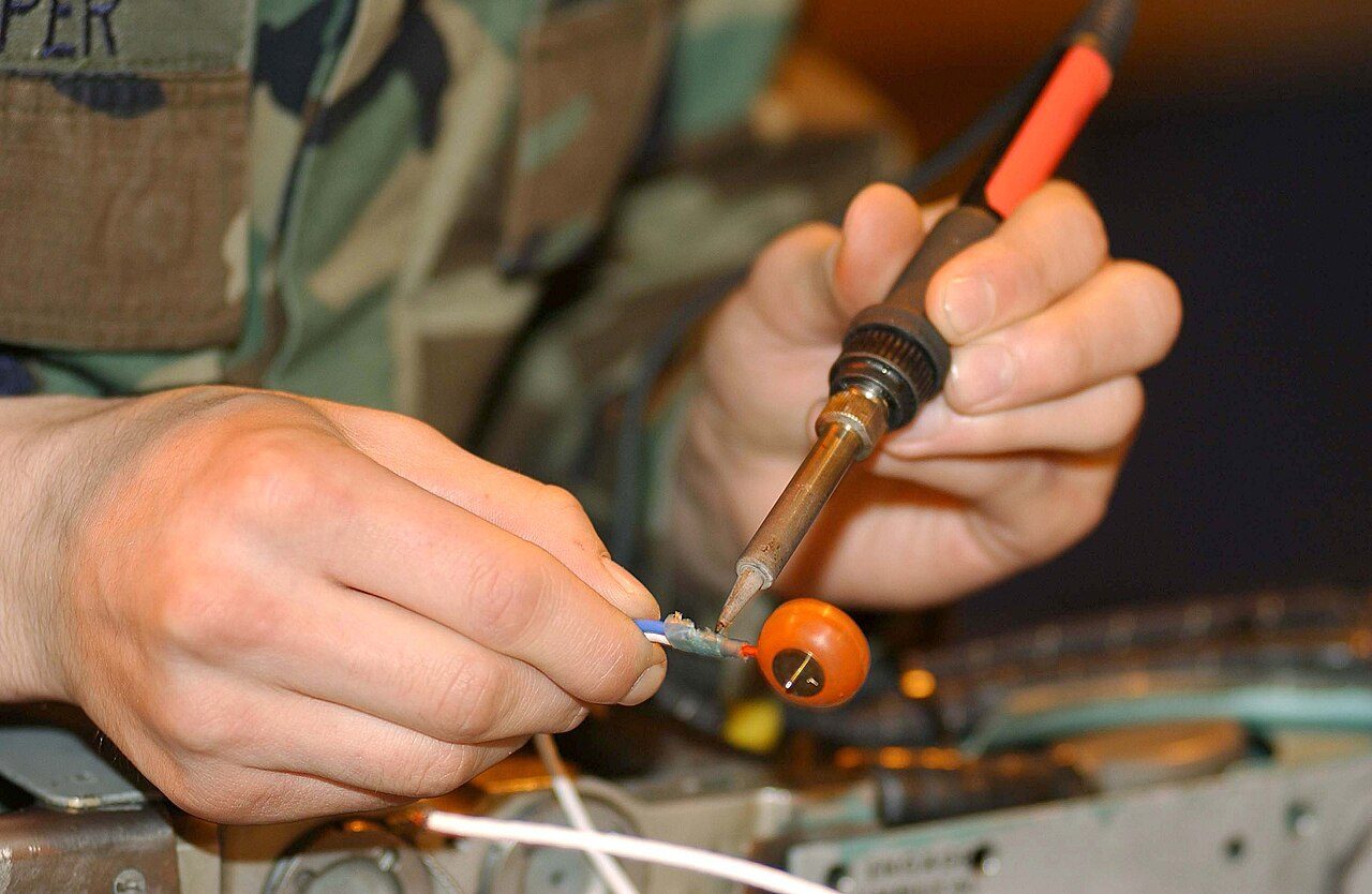 ROYAL AIR FORCE LAKENHEATH, England -- Airman 1st Class Jeremy Clapper desolders the firing contact on a LAU-106 missile launcher here April 7. Airman Clapper is an armament systems apprentice with the 48th Munitions Squadron.