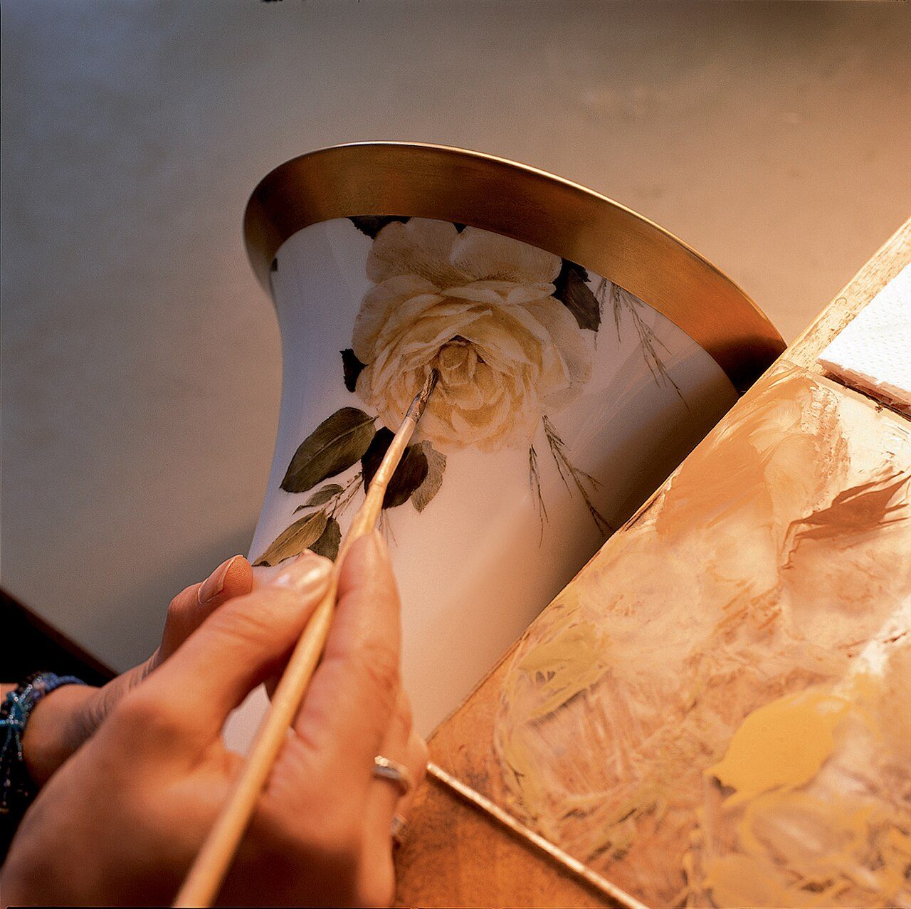 Porcelaine production, painting of a vase by hand