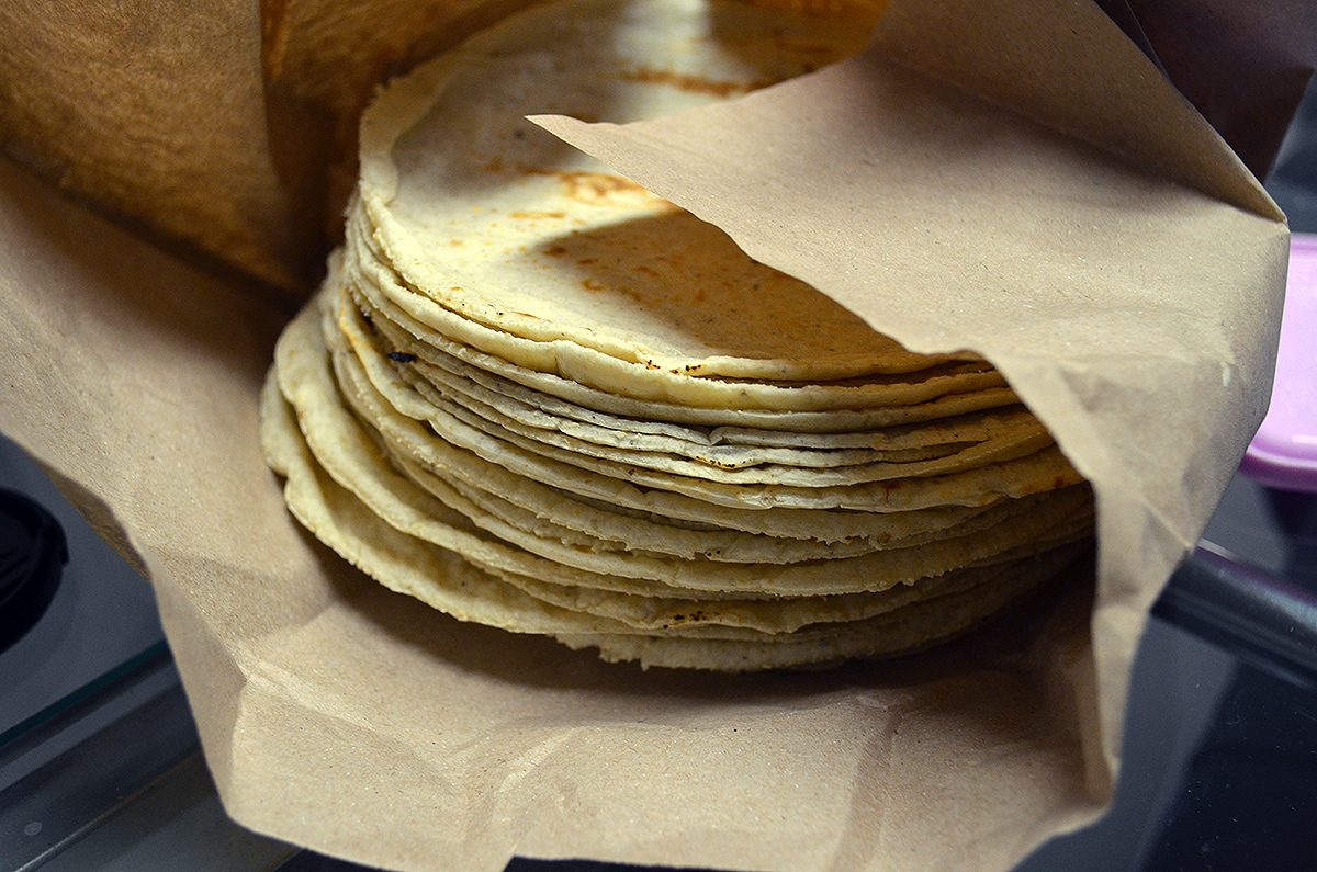 Photo of a kilo of tortillas, wrapped in paper, made in a machine in Mexico City. Keywords: Tortilla, Close up, Tortillería.
